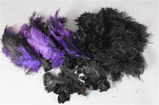 A collection of black feathers and two feather boas
